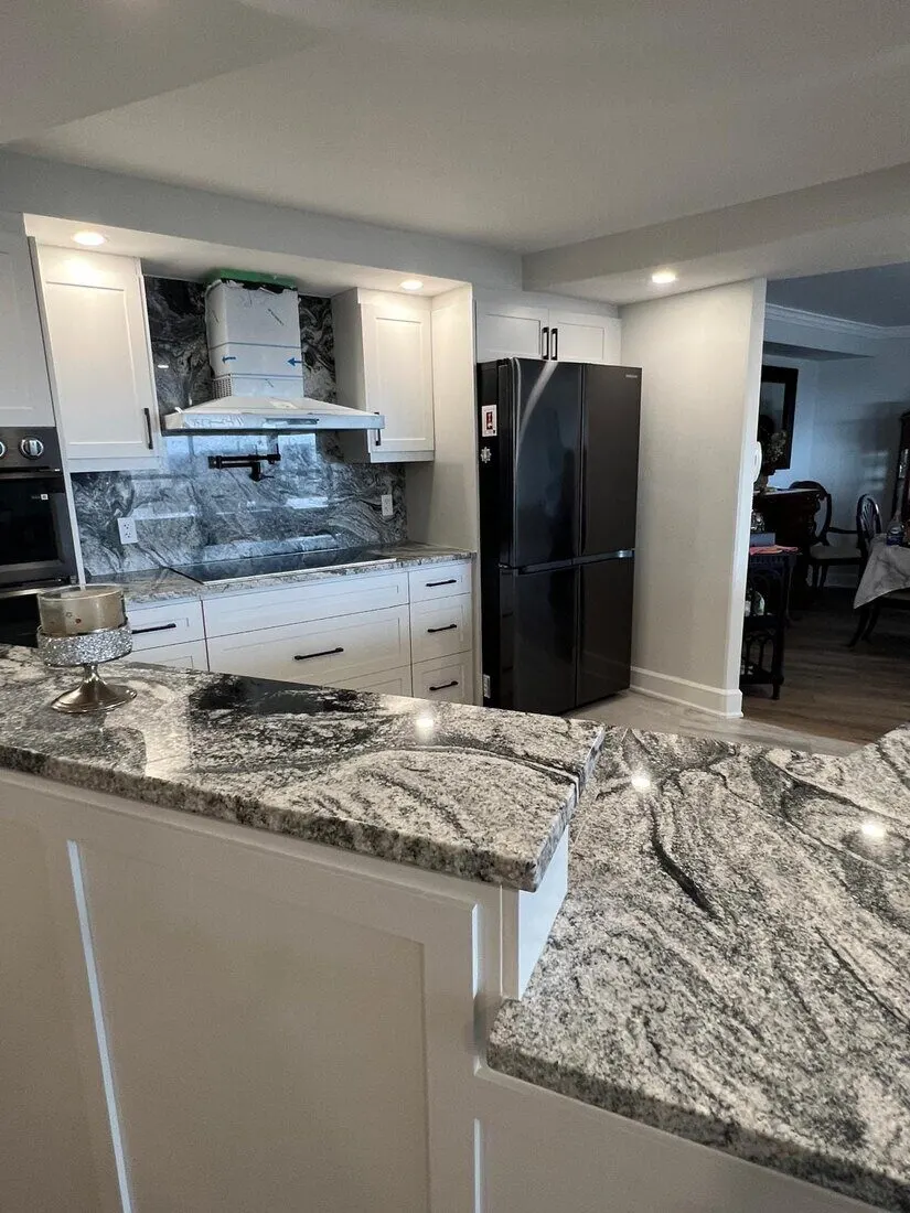 Kitchen with white cabinets and granite counters